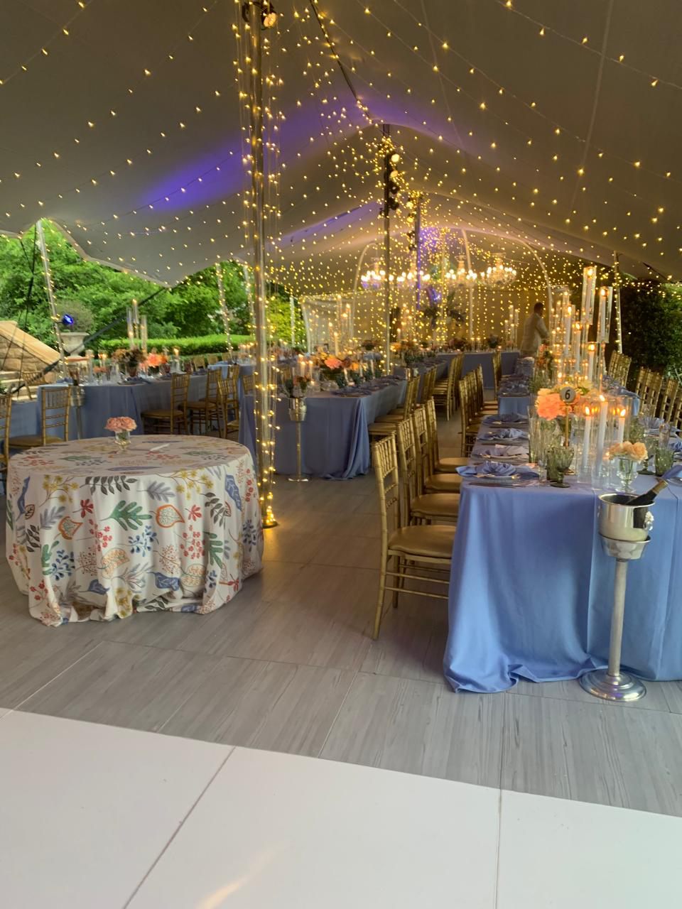 Elegant corporate event setup with lighting and dining tables