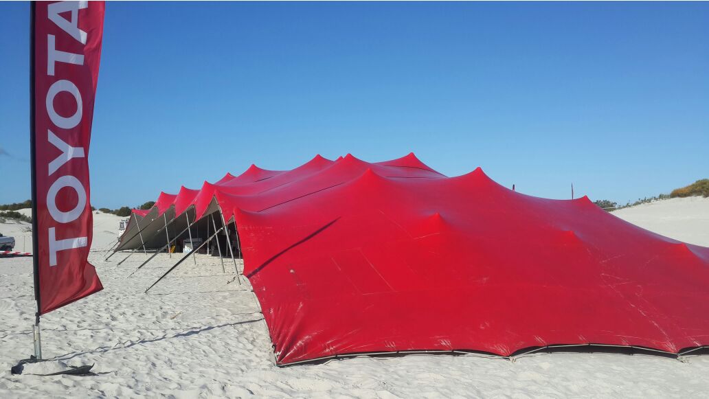 Red outdoor stretch tent setup