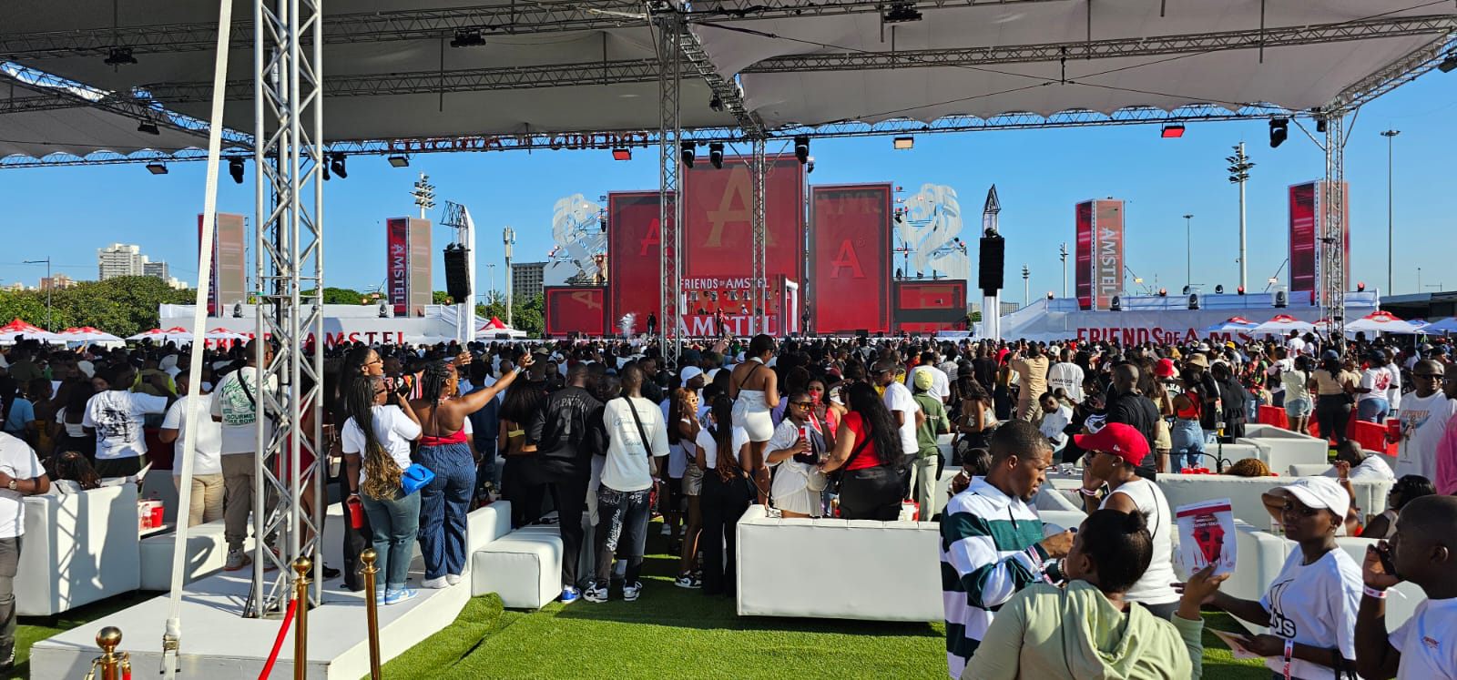 Large outdoor event crowd and branded stage setup