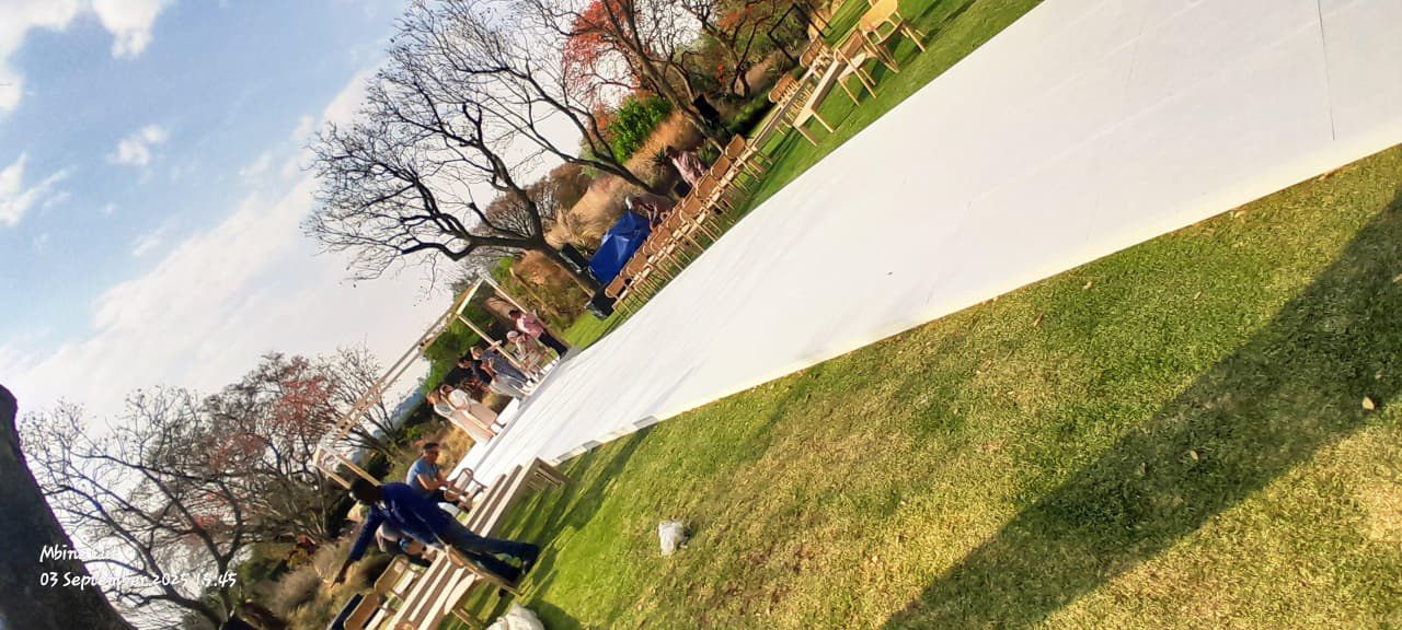 Outdoor wedding flooring installation on a lawn