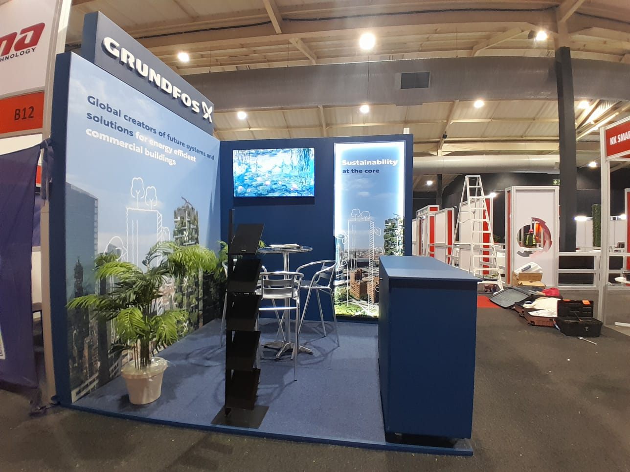 Custom exhibition stand with counters and meeting area