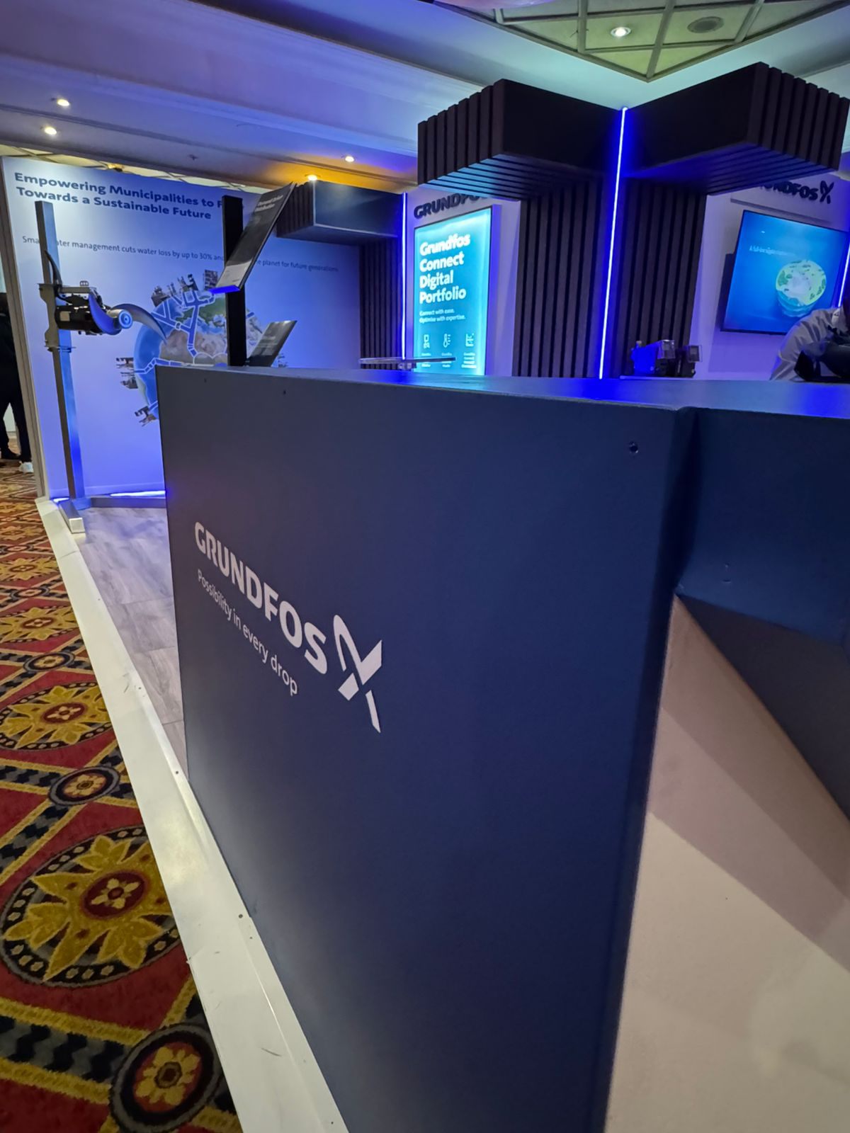 Custom branded reception counter with blue lighting